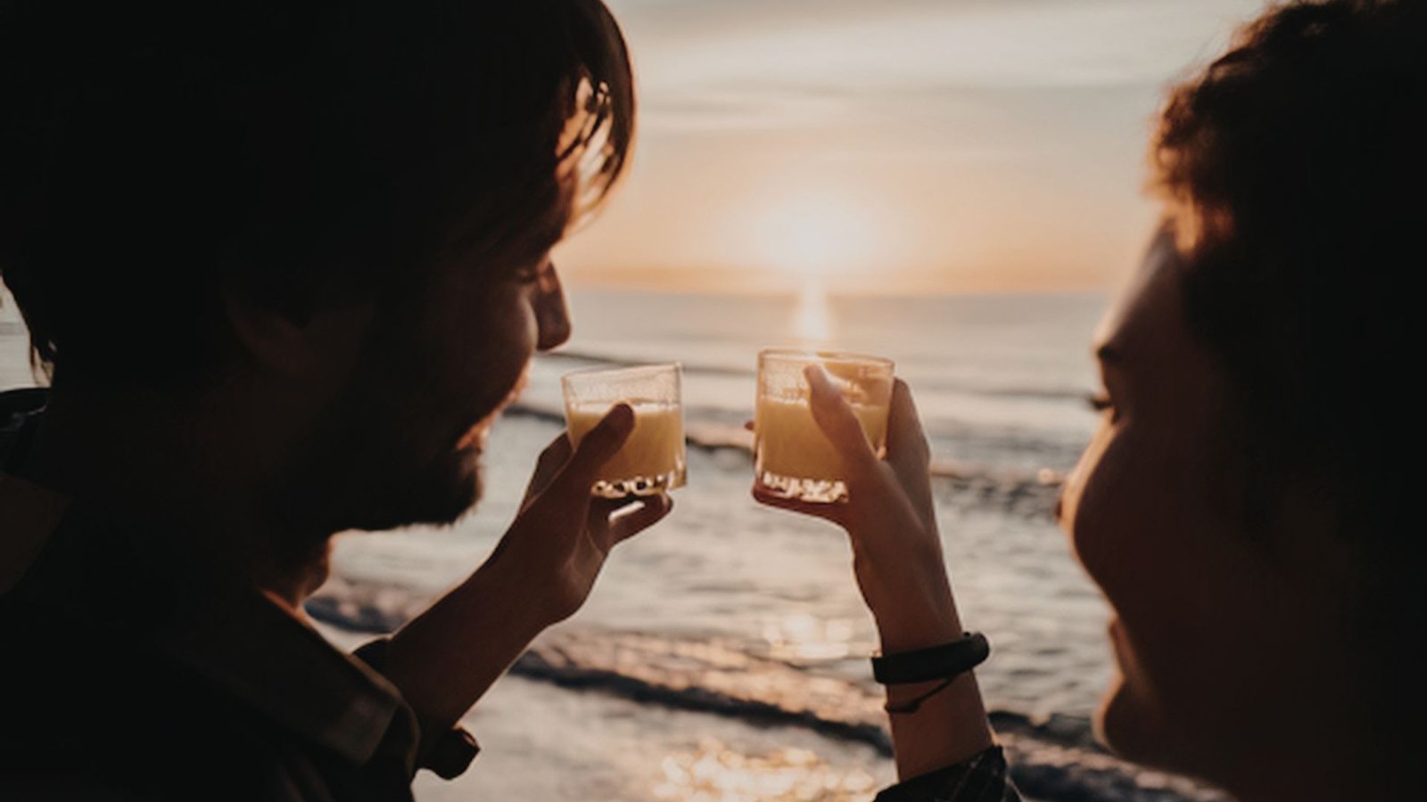 Couple drinking wine on the terrace at sunset in St. Maarten